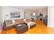 Inviting living room with a comfortable sectional sofa, ottoman, and hardwood floors at 1150 Collier Nw Rd # B5, Atlanta, GA 30318