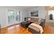 Well-lit living room featuring hardwood floors, a cozy sectional, and patio access at 1150 Collier Nw Rd # B5, Atlanta, GA 30318