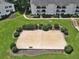 Aerial view of a sand volleyball court surrounded by lush greenery in a well-maintained community at 1150 Collier Nw Rd # B5, Atlanta, GA 30318