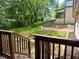 View from stained back deck stairs overlooking the green leafy yard and new construction in background at 256 New Hope Rd, Lawrenceville, GA 30046