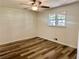 This bedroom features new floors, a ceiling fan, and a window providing natural light at 256 New Hope Rd, Lawrenceville, GA 30046