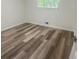This bedroom features new floors and a window providing natural light at 256 New Hope Rd, Lawrenceville, GA 30046