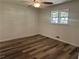 This bedroom features new floors, a ceiling fan, and a window providing natural light at 256 New Hope Rd, Lawrenceville, GA 30046