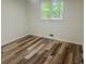 This bedroom features new floors and a window providing natural light at 256 New Hope Rd, Lawrenceville, GA 30046