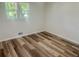 This bedroom features new floors and a window providing natural light at 256 New Hope Rd, Lawrenceville, GA 30046