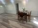 The dining area features a classic table set, neutral wall paint, and wood-look flooring at 256 New Hope Rd, Lawrenceville, GA 30046