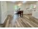 Dining area with wood-look floors, stylish light fixture, and sliding glass doors to the patio at 256 New Hope Rd, Lawrenceville, GA 30046