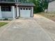 Long driveway leading to a one-car garage, showcasing ample parking space at 256 New Hope Rd, Lawrenceville, GA 30046