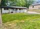 Traditional home with a well-maintained front lawn, front porch, and a single car garage at 256 New Hope Rd, Lawrenceville, GA 30046