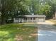 Home exterior featuring a front porch, attached garage, and spacious front yard at 256 New Hope Rd, Lawrenceville, GA 30046