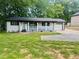 Well-kept home featuring a covered porch, attached garage and ample front yard space at 256 New Hope Rd, Lawrenceville, GA 30046