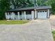 Home with a front porch, attached garage, and a wide driveway at 256 New Hope Rd, Lawrenceville, GA 30046