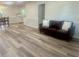 Inviting living room features wood-look flooring, a leather sofa, and neutral wall paint at 256 New Hope Rd, Lawrenceville, GA 30046
