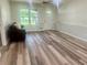 Spacious living room featuring wood-look floors, and a cozy seating area near the front door at 256 New Hope Rd, Lawrenceville, GA 30046