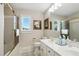 Bright bathroom with dual vanity and a framed mirror, offering a functional and well-lit space at 2845 Burgundy Dr, Cumming, GA 30041