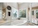 Bright bathroom with bay window, spa tub, and neutral decor at 2845 Burgundy Dr, Cumming, GA 30041