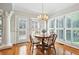 Sunlit dining area with hardwood floors, shuttered windows, and chandelier at 2845 Burgundy Dr, Cumming, GA 30041