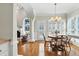 Sunlit dining area with hardwood floors, shuttered windows, and decorative columns at 2845 Burgundy Dr, Cumming, GA 30041