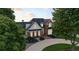 Stately brick home featuring a circular driveway, manicured landscaping, and elegant architectural details at 2845 Burgundy Dr, Cumming, GA 30041