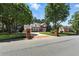 Street view of an attractive brick home with a circular driveway and manicured lawn, framed by mature trees and brick entrance columns at 2845 Burgundy Dr, Cumming, GA 30041