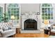 Elegant fireplace with white mantel, flanked by windows and seating area at 2845 Burgundy Dr, Cumming, GA 30041