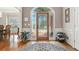 Inviting foyer with hardwood floors, decorative rug, and arched glass front door at 2845 Burgundy Dr, Cumming, GA 30041