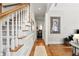 Elegant foyer with hardwood floors, staircase, and view into the laundry room at 2845 Burgundy Dr, Cumming, GA 30041