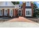 Close-up of a classic brick home featuring a brick walkway and manicured landscaping at 2845 Burgundy Dr, Cumming, GA 30041