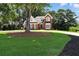 Charming brick home featuring a lush lawn and mature trees in a desirable neighborhood at 2845 Burgundy Dr, Cumming, GA 30041