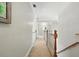 Bright hallway featuring neutral walls, white trim, and a staircase with wood railing, creating a welcoming passage at 2845 Burgundy Dr, Cumming, GA 30041