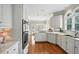 Bright kitchen with white cabinets, modern appliances, and hardwood floors at 2845 Burgundy Dr, Cumming, GA 30041