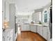 Bright kitchen with white cabinets, modern appliances, and hardwood floors at 2845 Burgundy Dr, Cumming, GA 30041