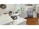 Inviting kitchen with white cabinets, stainless steel appliances, and hardwood floors at 2845 Burgundy Dr, Cumming, GA 30041