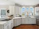 Stylish kitchen with white cabinets, stainless steel appliances, and hardwood floors at 2845 Burgundy Dr, Cumming, GA 30041