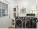 Laundry room with modern washer and dryer, storage and decor at 2845 Burgundy Dr, Cumming, GA 30041