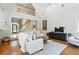Bright living room with vaulted ceilings, hardwood floors, and a view of the foyer at 2845 Burgundy Dr, Cumming, GA 30041