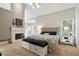 Comfortable main bedroom featuring a fireplace, ensuite sitting room, and neutral decor at 2845 Burgundy Dr, Cumming, GA 30041