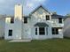 The house showcases a spacious backyard with well-maintained grass and a two-story, light-beige exterior elevation at 4189 Post Oak Grv, Atlanta, GA 30349