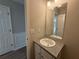 Bathroom with a white vanity, granite countertop, and a framed mirror adding a touch of elegance at 4189 Post Oak Grv, Atlanta, GA 30349