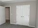 Bedroom with plush carpeting and a double door closet for ample storage at 4189 Post Oak Grv, Atlanta, GA 30349