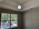 Bedroom showcasing a modern light fixture and a large window providing natural light at 4189 Post Oak Grv, Atlanta, GA 30349