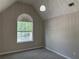 Bedroom features a vaulted ceiling, natural lighting from a window and cozy carpeting at 4189 Post Oak Grv, Atlanta, GA 30349