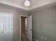Neutral bedroom with a view into another room, with a decorative light fixture at 4189 Post Oak Grv, Atlanta, GA 30349