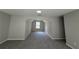 Bonus room with cozy carpeting and a unique design, featuring a window view and recessed lighting to complete the space at 4189 Post Oak Grv, Atlanta, GA 30349