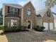 Charming two-story brick home with well-manicured lawn and attached two-car garage at 4189 Post Oak Grv, Atlanta, GA 30349