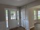 Inviting foyer with new hard surface flooring and natural light streaming through the sidelight windows at 4189 Post Oak Grv, Atlanta, GA 30349