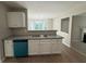 View of the kitchen, with granite countertops and stainless steel appliances, leading into the dining area at 4189 Post Oak Grv, Atlanta, GA 30349