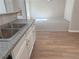 Open-concept kitchen with stainless steel sink and view into the spacious living area at 4189 Post Oak Grv, Atlanta, GA 30349