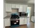 Bright kitchen features white cabinets, gray countertops, and new stainless steel appliances at 4189 Post Oak Grv, Atlanta, GA 30349