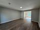 Spacious open living room with updated luxury vinyl plank flooring and neutral paint at 4189 Post Oak Grv, Atlanta, GA 30349